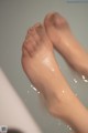 A close up of a person's feet in a bathtub.