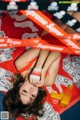 A woman laying on top of a pile of money.