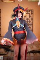A woman in a costume is posing for a picture.