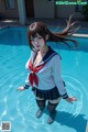 A woman in a sailor outfit standing in a pool.