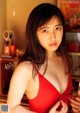 A woman in a red dress posing for a picture.