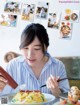 A woman sitting at a table with a plate of food.