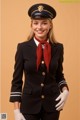 A woman in a pilot's uniform poses for a picture.